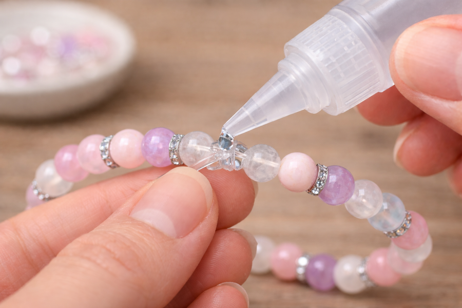 Ajouter une goutte de colle sur le nœud d’un bracelet élastique
